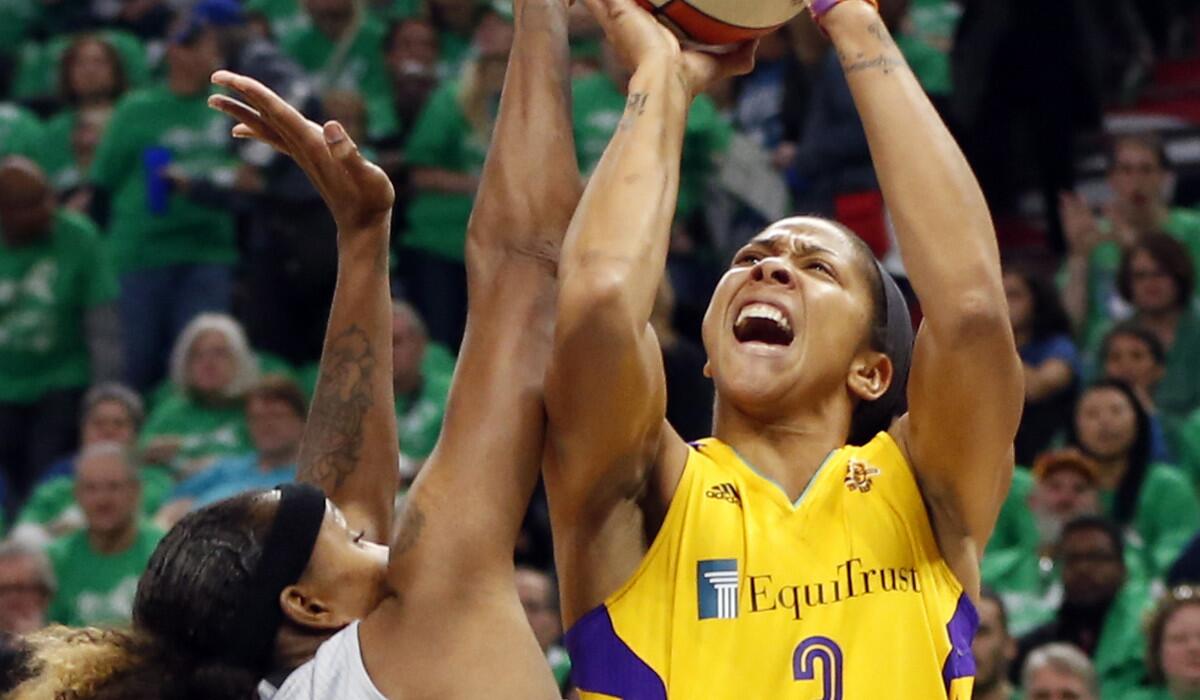 Sparks' Candace Parker, right, attempts to shoot over Minnesota Lynx's Rebekkah Brunson in the first quarter during Game 5 of the WNBA basketball finals Thursday.