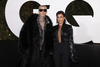 Travis Barker, left, and Kourtney Kardashian arrive at the 2022 GQ Men of the Year Party on Thursday, Nov. 17, 2022, at the West Hollywood Edition in West Hollywood, Calif. (Photo by Willy Sanjuan/Invision/AP)