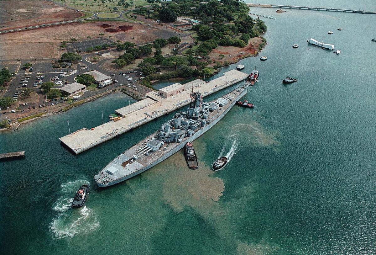 June 22, 1998: The battleship Missouri, "Mighty Mo," ties up to its new pier at Ford Island in Pearl Harbor, Hawaii. After a journey across the Pacific Ocean, the Mighty Mo joins the Arizona Memorial as symbols of the beginning and the end of World War II.