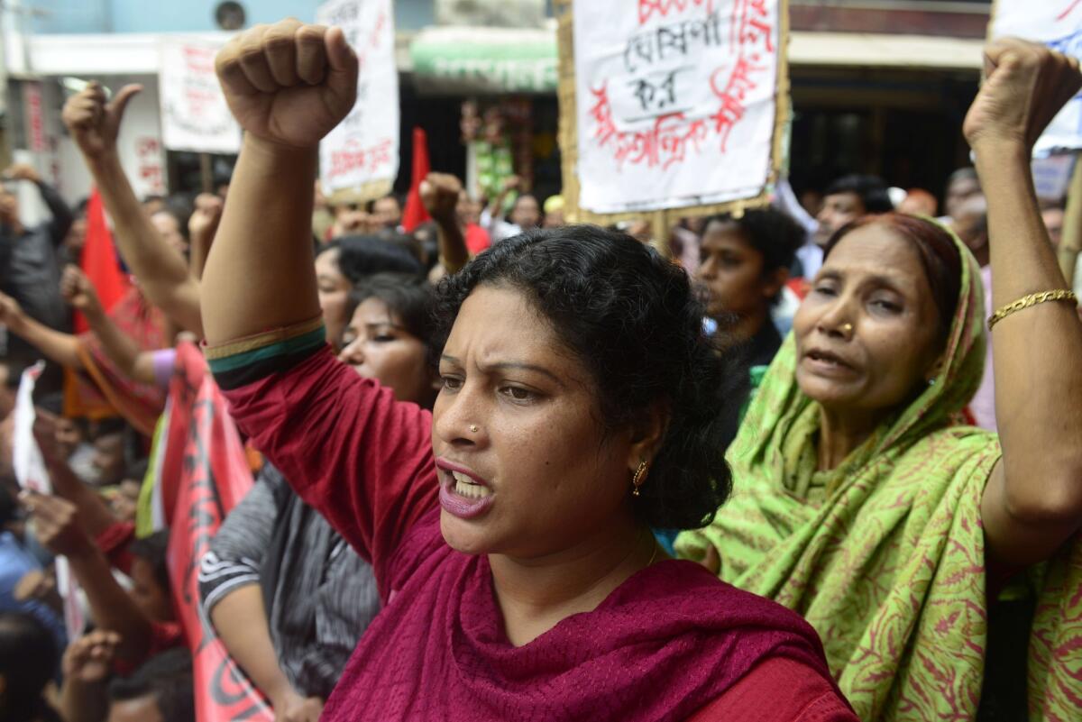 Bangladeshi garment workers shout slogans during a protest demanding wage increases in Dhaka.