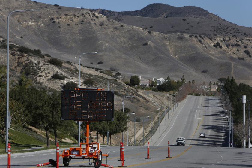A sign in Porter Ranch alerts residents to call 911 to report crime in the area. More than 2,000 people have been placed in temporary housing because of a gas leak at the nearby Aliso Canyon storage facility.