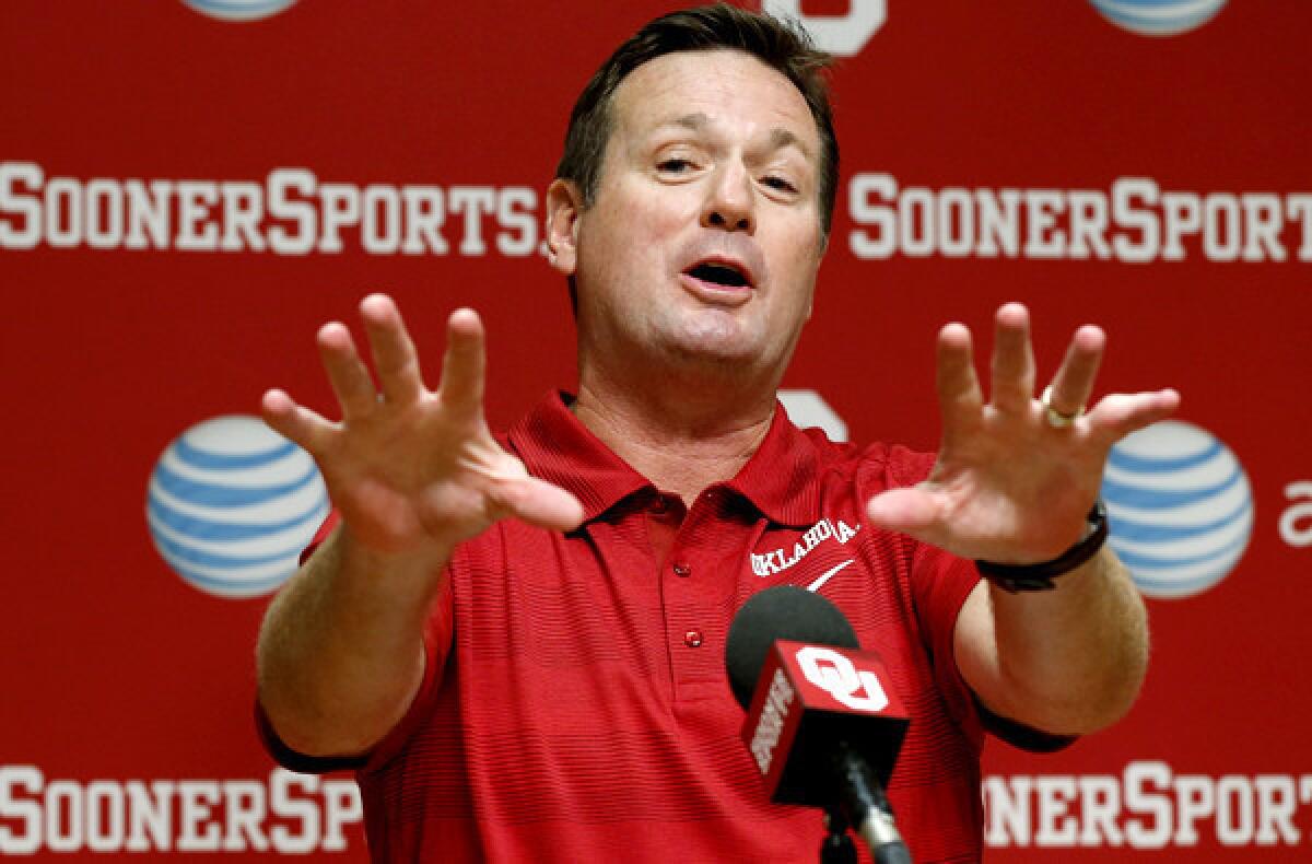 Oklahoma Coach Bob Stoops answers a question at a news conference Saturday in Norman, Okla.