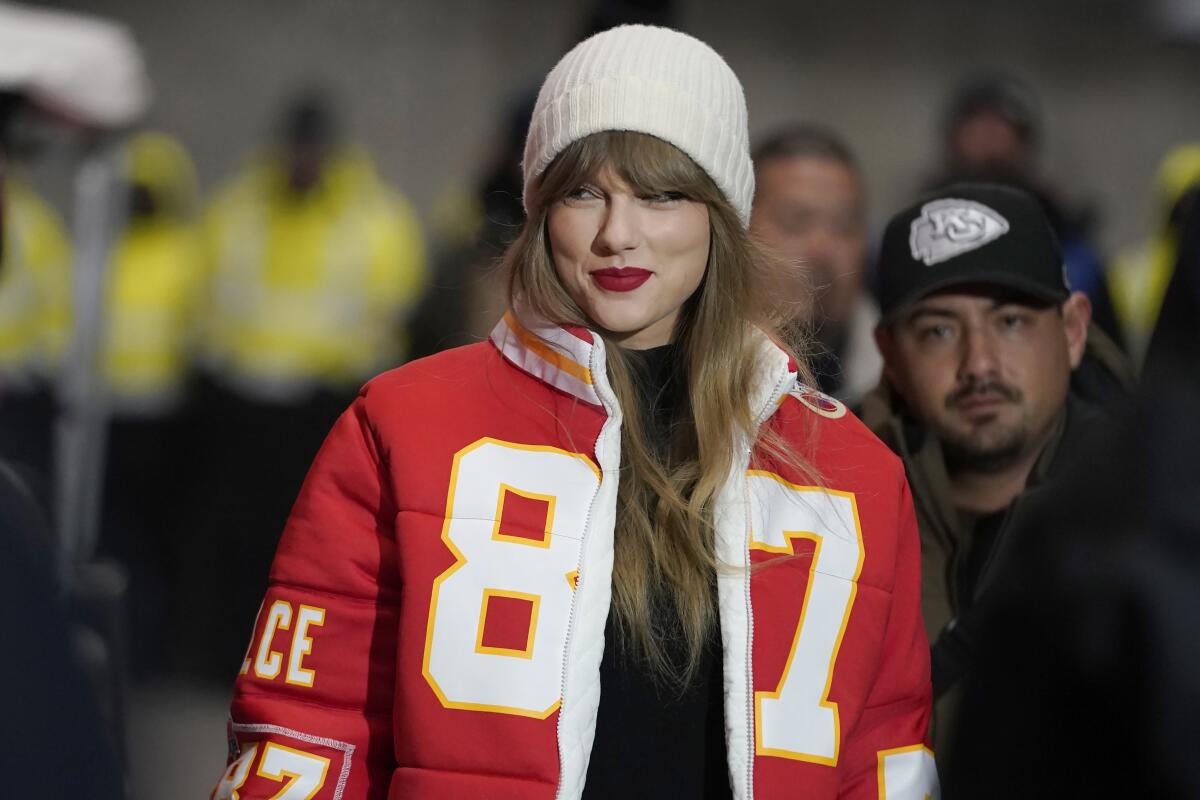 Taylor Swift wears a Travis Kelce No. 87 jacket as she arrives at Arrowhead Stadium.