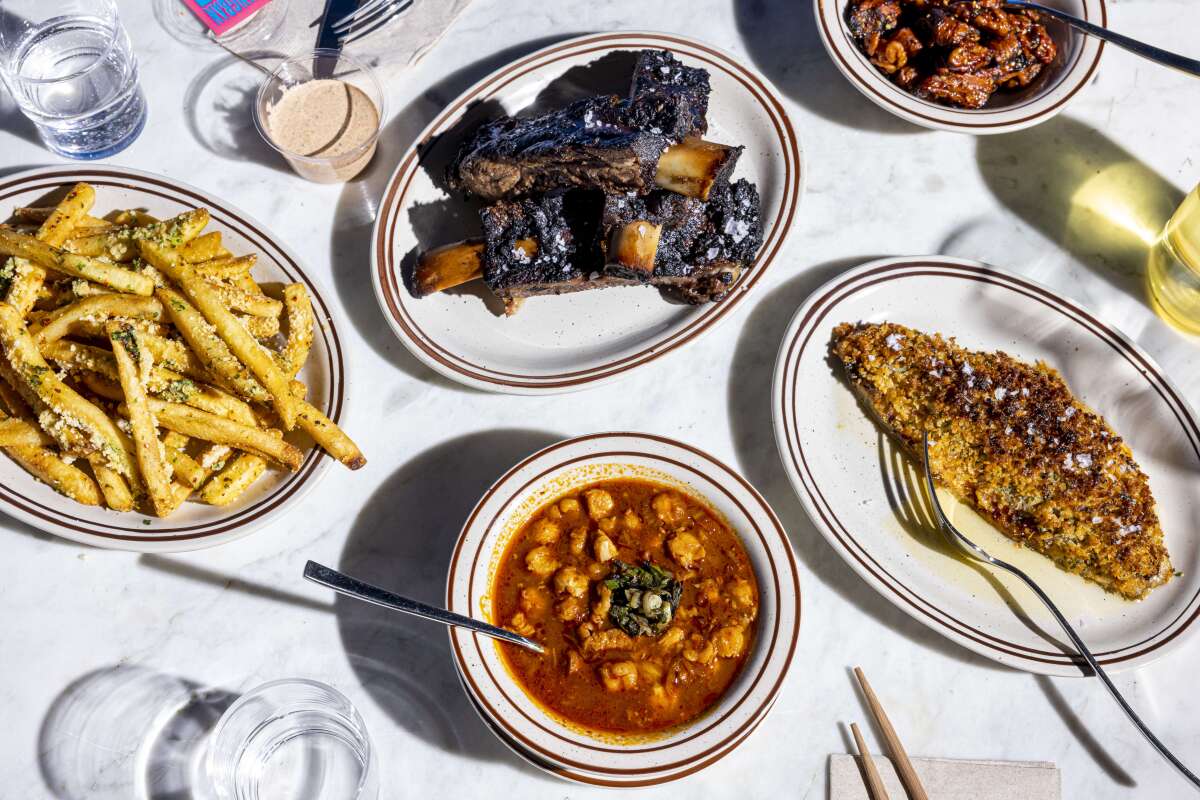 LOS ANGELES, CALIFORNIA, Jan 8, 2022: (Center bottom) Kimchi Pozole (A stew made with pork belly, aged kimchi, chile negro, ancho, chipotle, and rancho gordo hominy, garnished with grilled scallions & roasted jalapenos), (R) Sea Bream (Broiled sea bream with chili daikon paste, and toasted breadcrumb), and (center top) Beef Back Rib "galbi" (Brandt beef back ribs marinated & grilled over charcoal) from Arts District's newest restaurant addition, Yangban Society from chef / owners Katianna and John Hong, photographed on Saturday, Jan. 8, 2021, in the Arts District on Santa Fe street in downtown Los Angeles. (Silvia Razgova / For The Times)