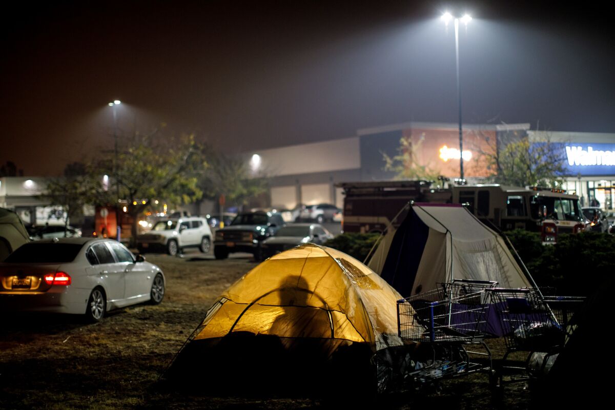 Evacuees from the Camp fire are taking shelter in tents and their vehicles in a Walmart parking lot in Chico. (Marcus Yam / Los Angeles Times)