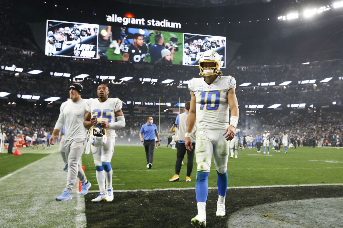 Justin Herbert (10) of the Los Angeles Chargers walks off the field after being defeated by the Las Vegas Raiders.