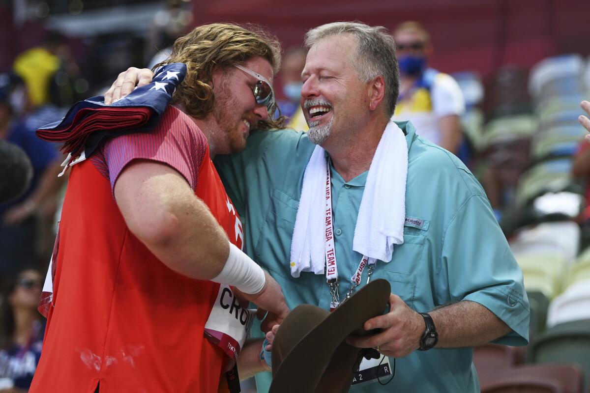 U.S. shot putter Ryan Crouser celebrates with his father and coach, Mitch Crouser.