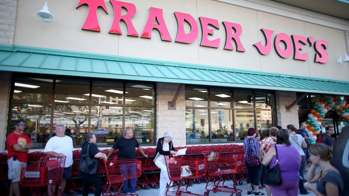 Shoppers wait for the grand opening of a Trader Joe's in Pinecrest, Fla., in 2013.