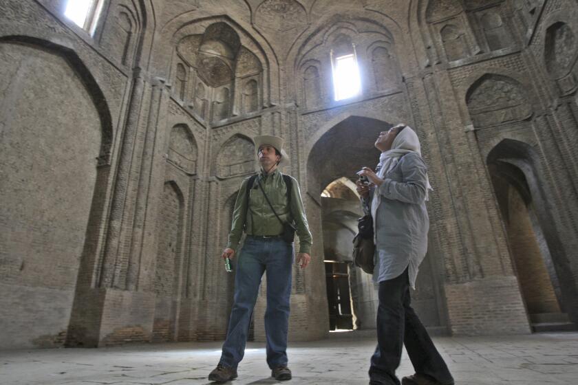 Canadian tourist David Froud, left, and his Iranian wife Mahnaz sight see the Jomeh mosque, which is now a historical monument, in the city of Isfahan, some 234 miles (390 kilometer) south of the capital Tehran, Iran.