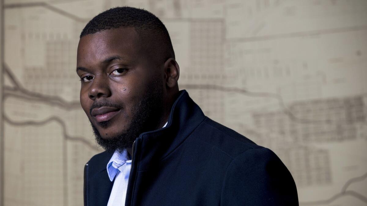 Mayor Michael Tubbs poses for a portrait in front of a map of the city of Stockton in his office