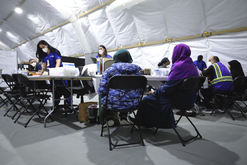زنان پناهنده افغان در چادر پزشکی در لیبرتی ویلج نیوجرسی منتظر معاینه توسط پزشک هستند.