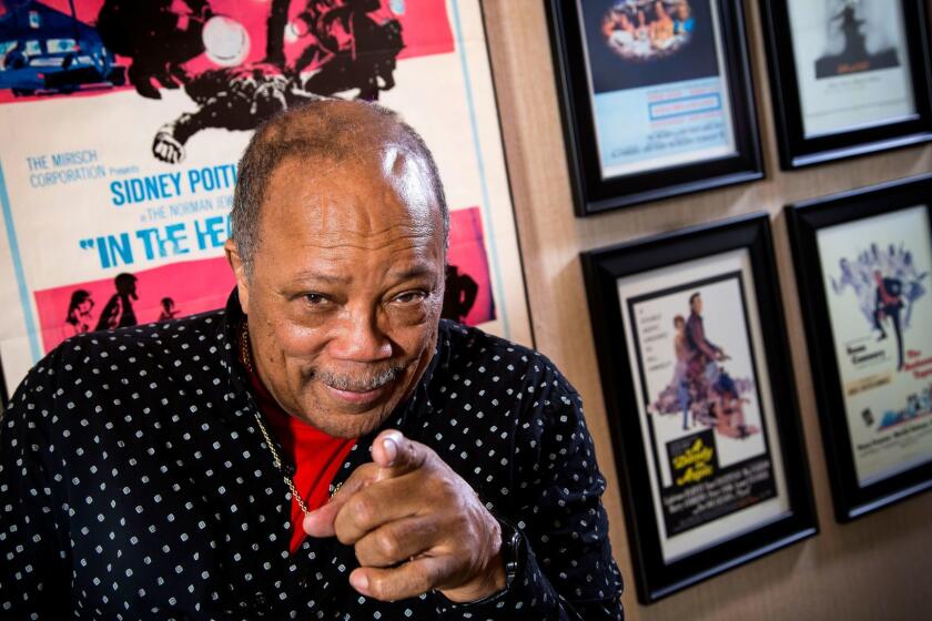 BEL AIR, CA - MARCH 20, 2014 - Legendary composer, musician, producer, activist Quincy Jones at his home in Bel Air, Thursday, March 20, 2014, in front of pictures of movies he's written the scores. For a story about the TCM Classic Film festival, complete with a screening of 1965's "The Pawnbroker," for which he wrote the score. (Ricardo DeAratanha/Los Angeles Times).
