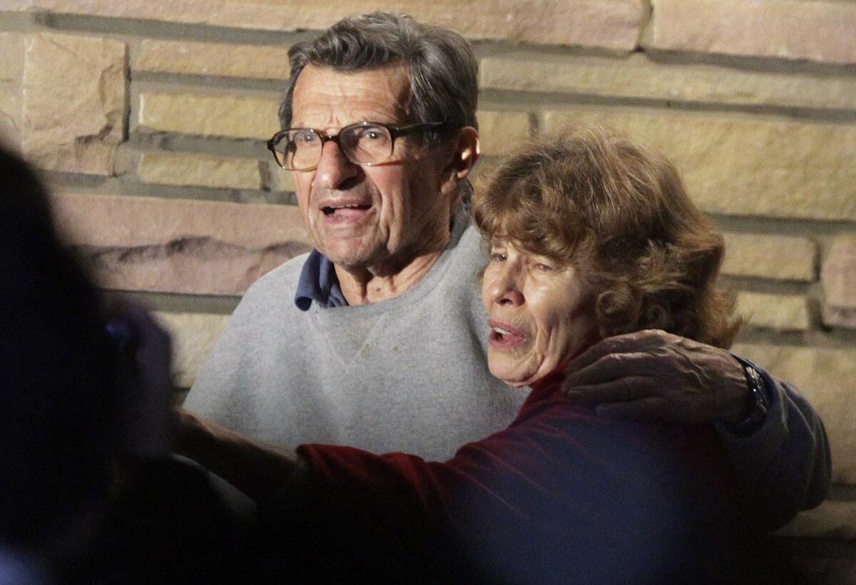 Joe and Sue Paterno stand on their porch.