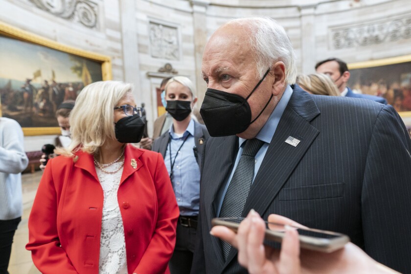 Former Vice President Dick Cheney walks with his daughter Rep. Liz Cheney, R-Wyo., vice chair of the House panel investigating the Jan. 6 U.S. Capitol insurrection, in the Capitol Rotunda at the Capitol in Washington, Thursday, Jan. 6, 2022. (AP Photo/Manuel Balce Ceneta)