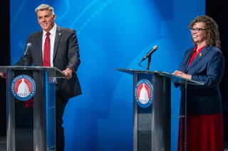 Candidates Phil Lyman and Celeste Maloy smile at the end of a congressional debate in Salt Lake City.