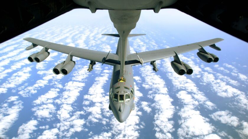 A U.S. Air Force B-52 bomber refuels after returning from a 2003 mission in Iraq with empty bomb racks under its wings.