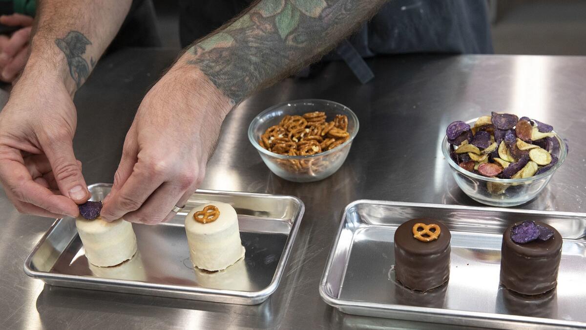 Scotty Blenkarm, the head of the R&D Lab at Milk Bar in Los Angeles, adds finishing touches to the Compost pocket cake.