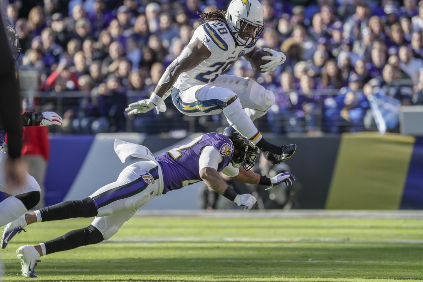 Chargers running back Melvin Gordon leaps over Ravens cornerback Jimmy Smith for a short gain during the first half.