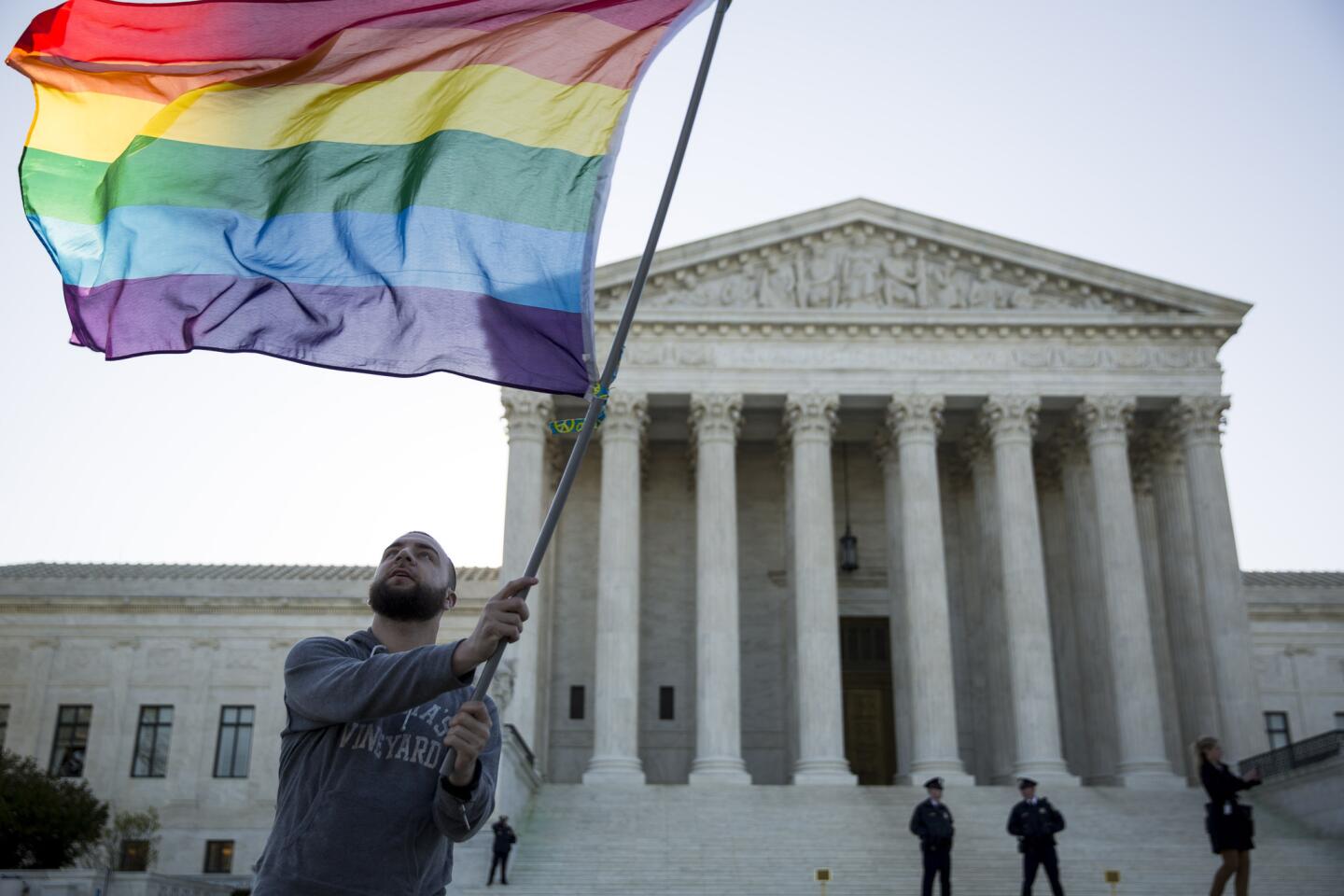 Same-sex marriage supporter Vin Testa waves a rainbow pride flag near the Supreme Court in Washington, DC. On Tuesday the Supreme Court will hear arguments concerning whether same-sex marriage is a constitutional right, with decisions expected in June.