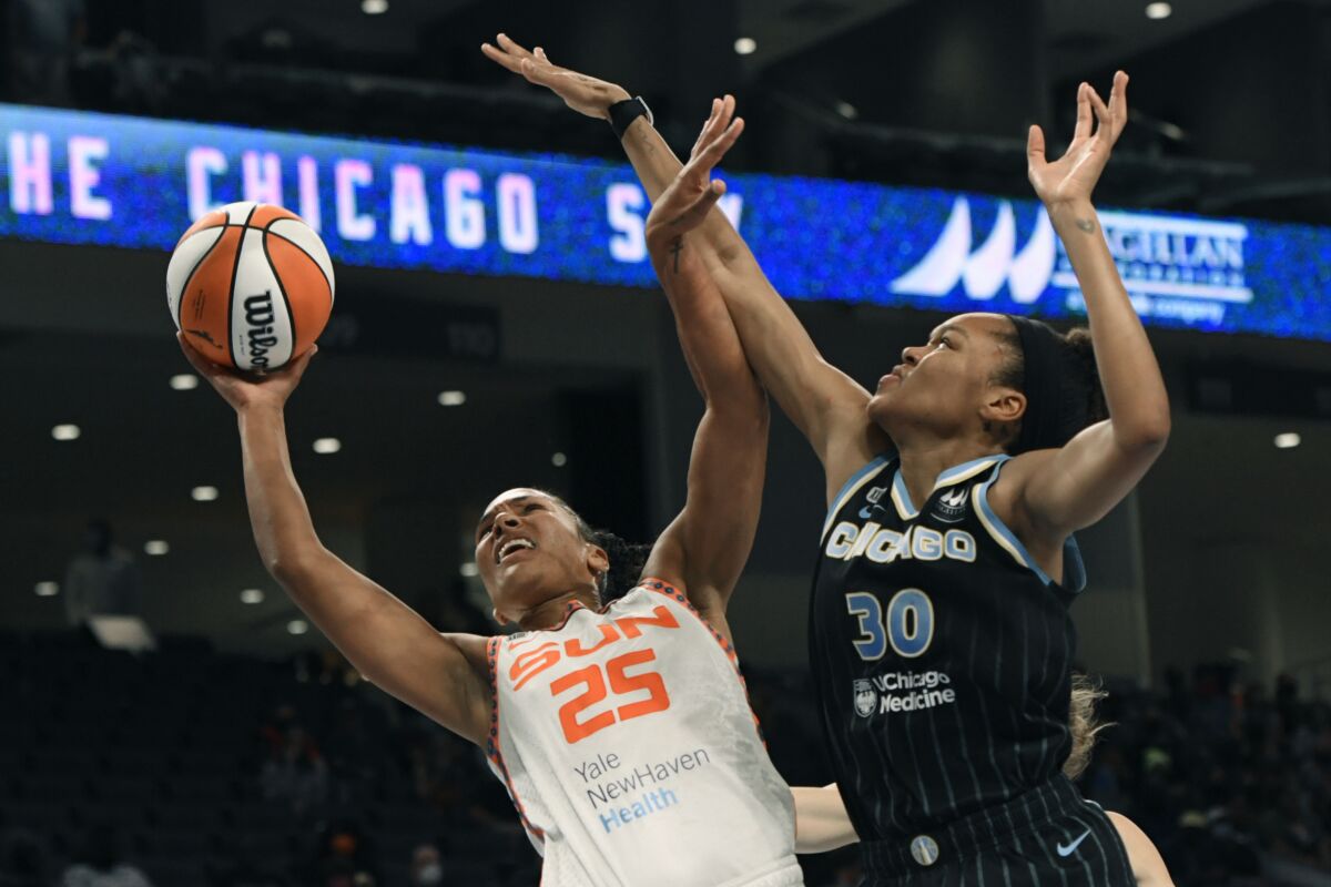 Connecticut Sun's Alyssa Thomas (25) goes up to shoot against Chicago Sky's Azura Stevens (30) during the first half of Game 3 in the semifinals of a WNBA playoff basketball game Sunday, Oct. 3, 2021, in Chicago. (AP Photo/Paul Beaty)