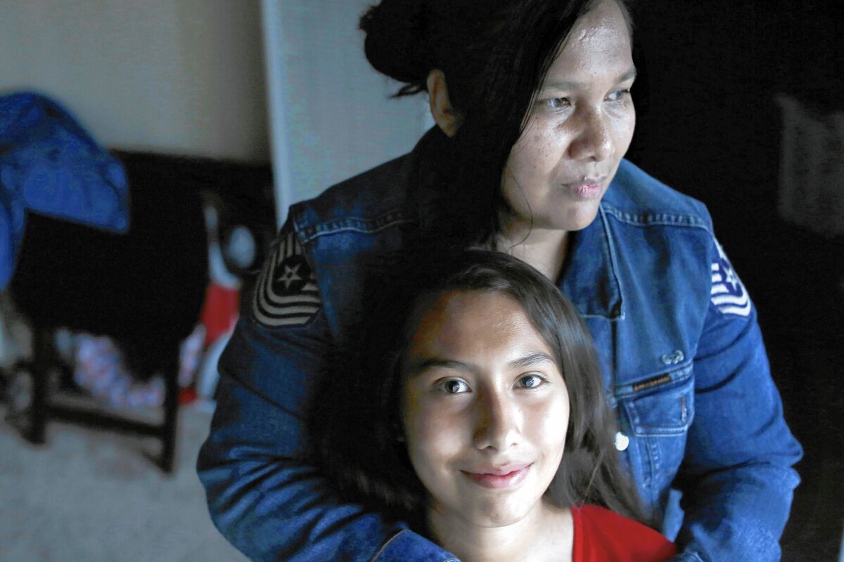 Lizeth Gallegos, 14, with her mother, Carolina Moran, in their Canoga Park apartment. Lizeth will be getting Medi-Cal health coverage.
