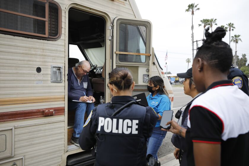 CHULA VISTA, CA - APRIL 27, 2022: Members of Chula Vista's HOT (Homeless Outreach Team) talk with Gary Burke who was living in his motor home on Wednesday, April 27, 2002 in Chula Vista, CA. From left are Chula Vista police officer Carly Schoch, Jessica Williams of San Diego County's Health and Human Services, Laura Diaz of San Diego County PERT, Psychiatric Emergency Response Team, and Turquoise Teagle of Veterans Village of San Diego. Burke accepted the services of Veterans Village and moved into their facility. (K.C. Alfred / The San Diego Union-Tribune)