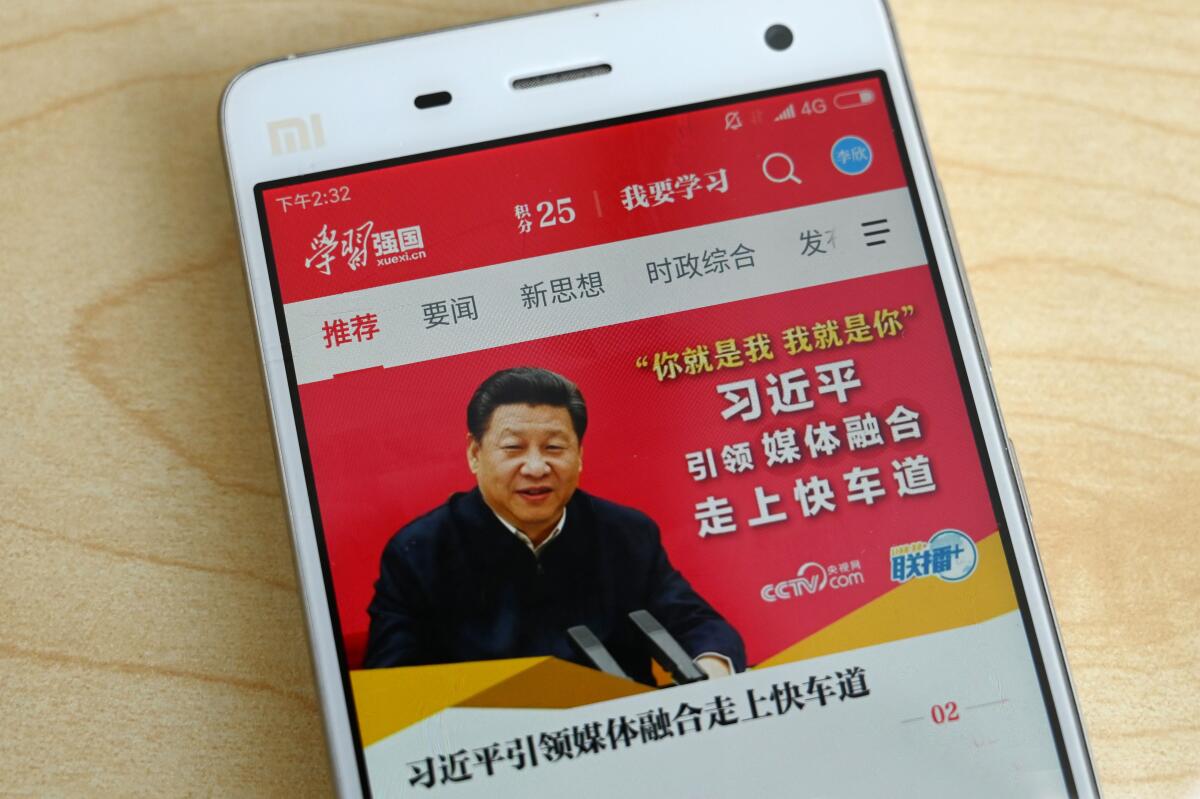 Chinese President Xi Jinping's image on a cellphone screen with Chinese characters around it.