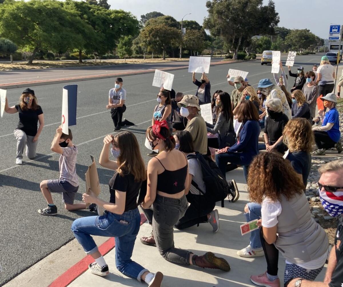 Protesters kneeled in front of Solana Beach City Hal on June 3 in remembrance of George Floyd.
