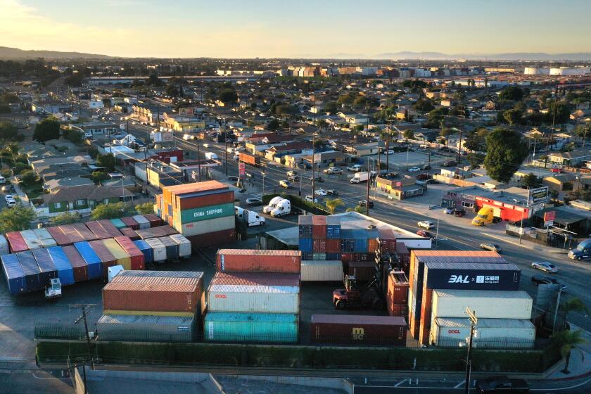 Wilmington, California-Feb. 24, 2022-Gilma Diaz is owner of New World Drayage, (shown in center) a container storage yard in Wilmington on Pacific Coast Highway. The number of containers in her container business varies each day. Photograph taken in late January 2022. (Carolyn Cole / Los Angeles Times)