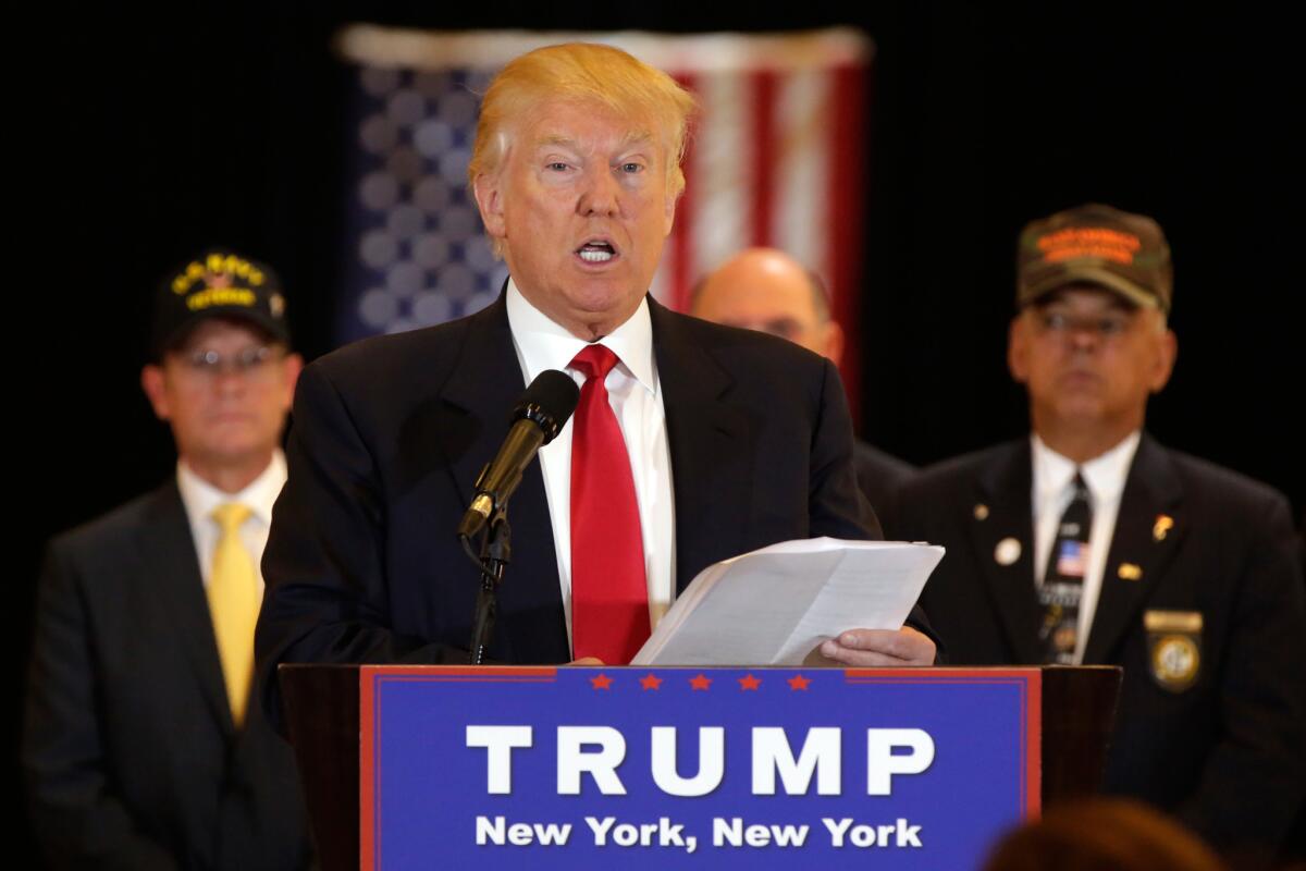 Republican presidential candidate Donald Trump reads from a list of donations to veteran's groups during a news conference in New York on May 31.