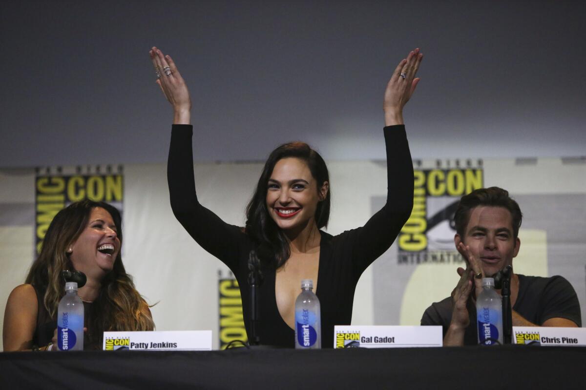 "Wonder Woman" star Gal Gadot recognizes the crowd after the film's trailer is revealed during a Saturday presentation at Comic-Con International in San Diego.