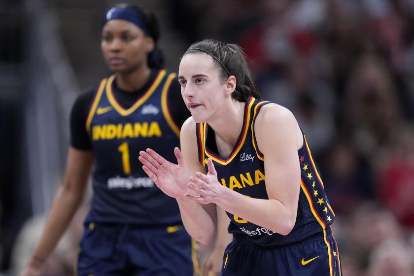 Indiana Fever guard Caitlin Clark reacts in the second half of a WNBA basketball game.