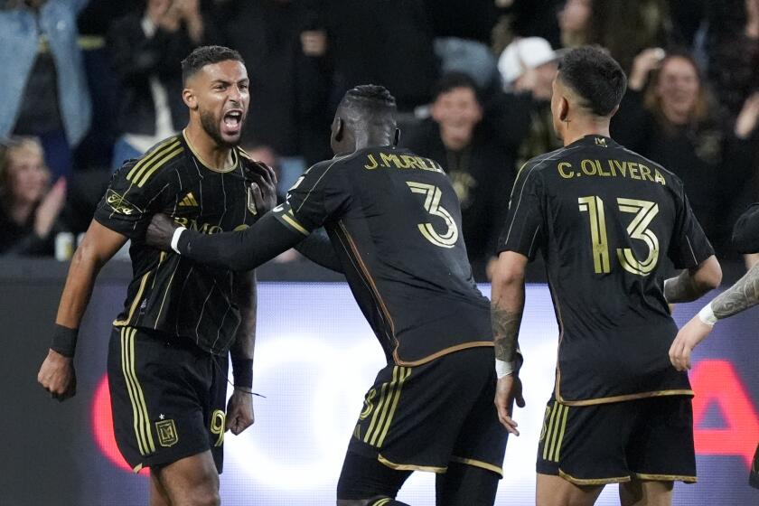 Los Angeles FC forward Denis Bouanga, left, celebrates his goal against the Portland Timbers with Jesus Murillo (3) and Cristian Olivera (13) during the second half of an MLS soccer match Saturday, April 27, 2024, in Los Angeles. (AP Photo/Marcio Jose Sanchez)