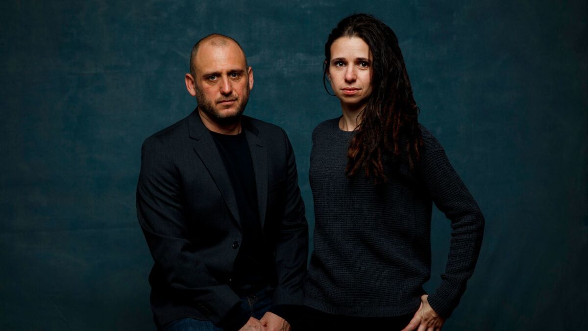 Directors Shaul Schwarz and Christina Clusiau are shown at the Sundance Film Festival in January, where their film was acquired by the Orchard and CNN.