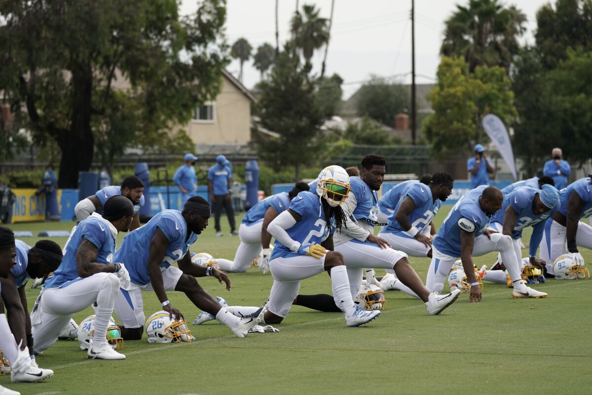 Chargers players stretch during practice.