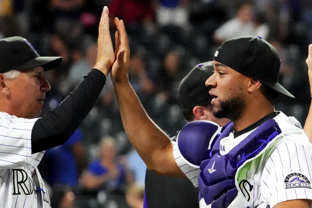 Colorado Rockies catcher Elias Diaz, right, high-fives manager Bud Black after beating the Dodgers on Tuesday.