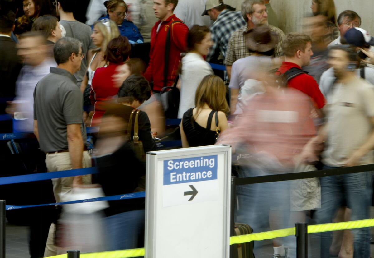 Passengers wind their way through a TSA checkpoint at Los Angeles International Airport.