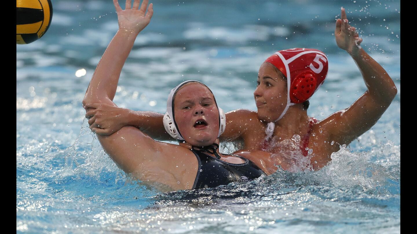 Lillian Gess of Newport Harbor High is grabbed by Orange Lutheran's Hannah Palmer (5) in the first half of the CIF Southern Section Division 1 quarterfinal playoff match at Santiago Canyon College on Thursday.