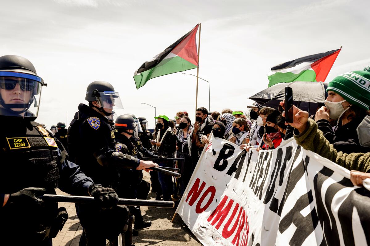 Demonstrators protesting the ongoing war in Gaza, block southbound traffic on Interstate 