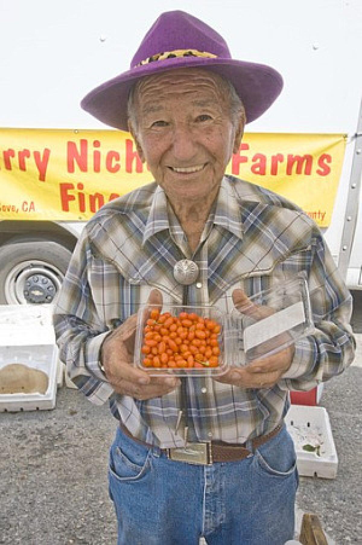Harry Nicholas, 88, sells goji berries grown by Charles Garrigus in Selma at the Beverly Hills farmers market.