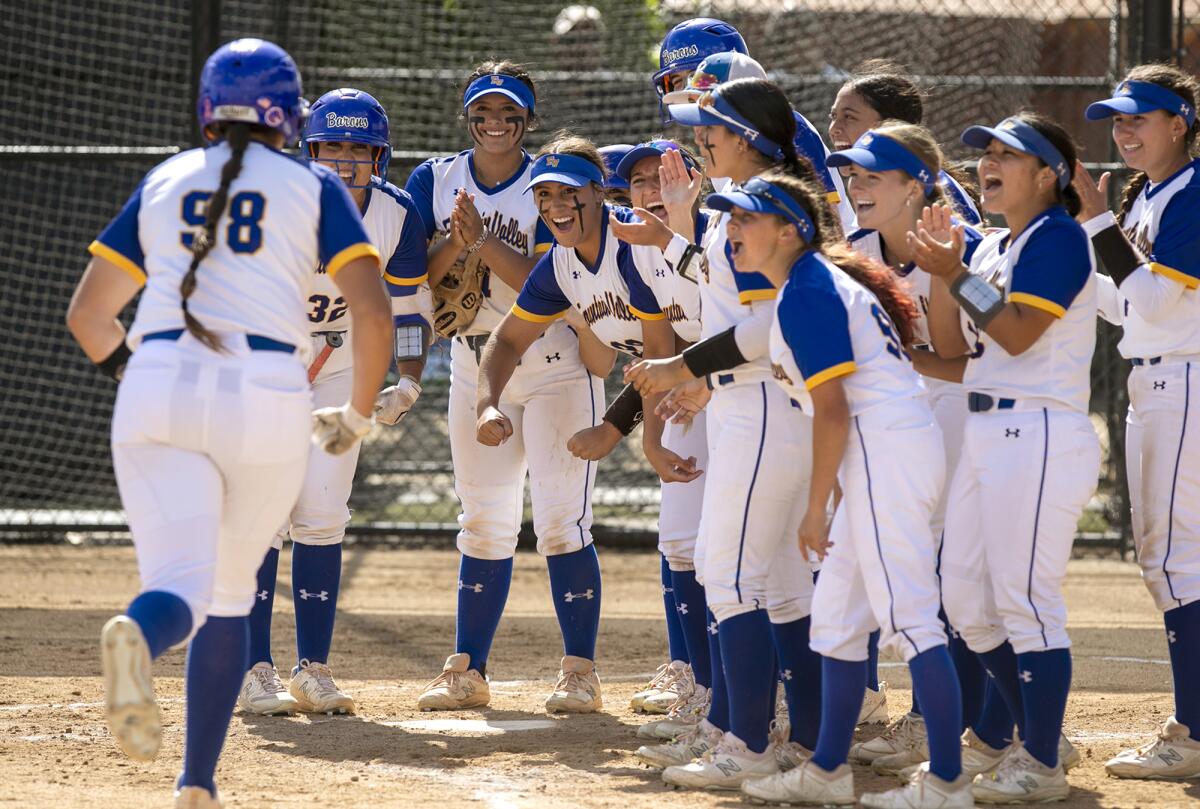 Fountain Valley's Makenzie Butt is mobbed by her teammates at the plate after she hits a solo home run.
