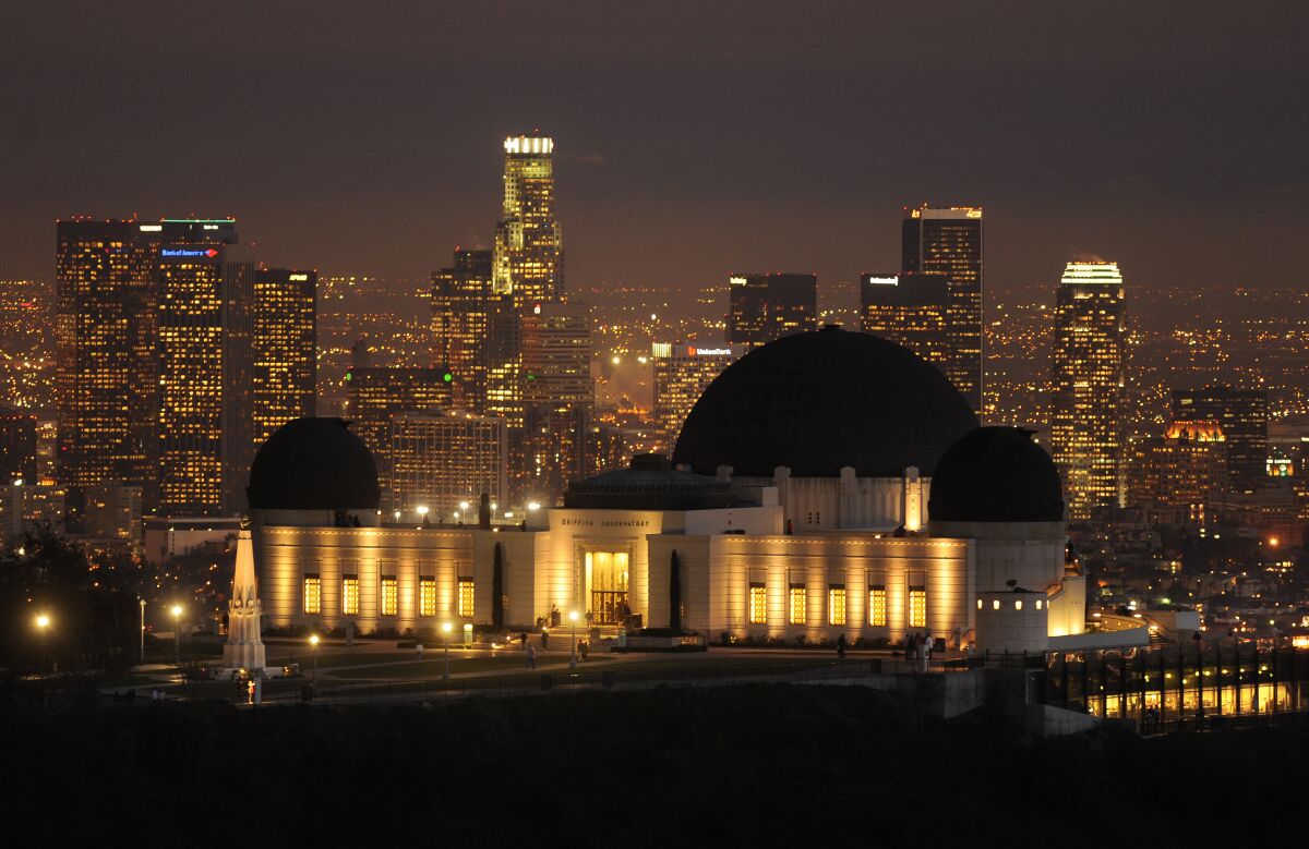 A view of the Griffith Observatory, with downtown Los Angeles sparkling in the background.