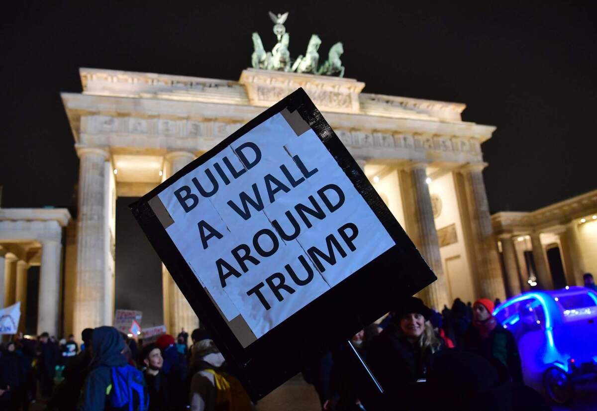 A protester at Berlin's iconic Brandenburg Gate offers his opinion of the new U.S. president.
