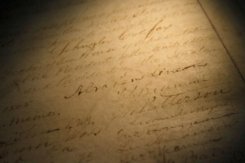 FILE - This Nov. 29, 2011, file photo shows the signature of president Abraham Lincoln on a rare, restored copy of the 13th Amendment that ended slavery, in Chicago. National lawmakers are expected on Wednesday, Dec. 2, 2020, to introduce a joint resolution aimed at striking language from the U.S. Constitution that enshrines a form of slavery in America’s foundational documents. (AP Photo/Charles Rex Arbogast, File)