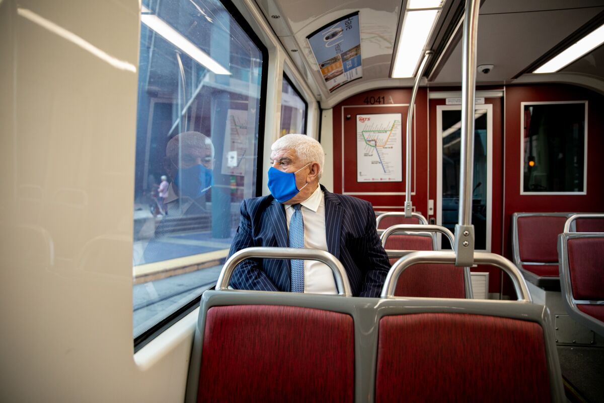 San Diego Association of Governments Executive Director Hasan Ikhrata rides the trolley.