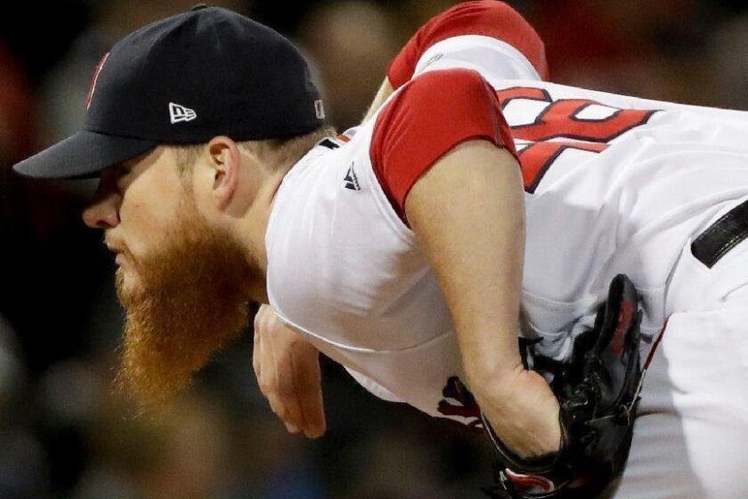 Boston Red Sox relief pitcher Craig Kimbrel looks to throw during the ninth inning in Game 2 of a baseball American League Championship Series against the Houston Astros on Sunday, Oct. 14, 2018, in Boston.(AP Photo/David J. Phillip)