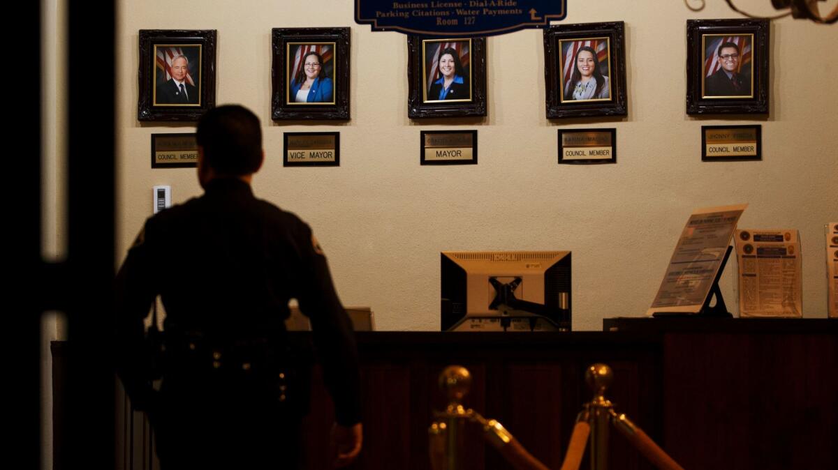 Portraits of Huntington Park council members are displayed inside City Hall.