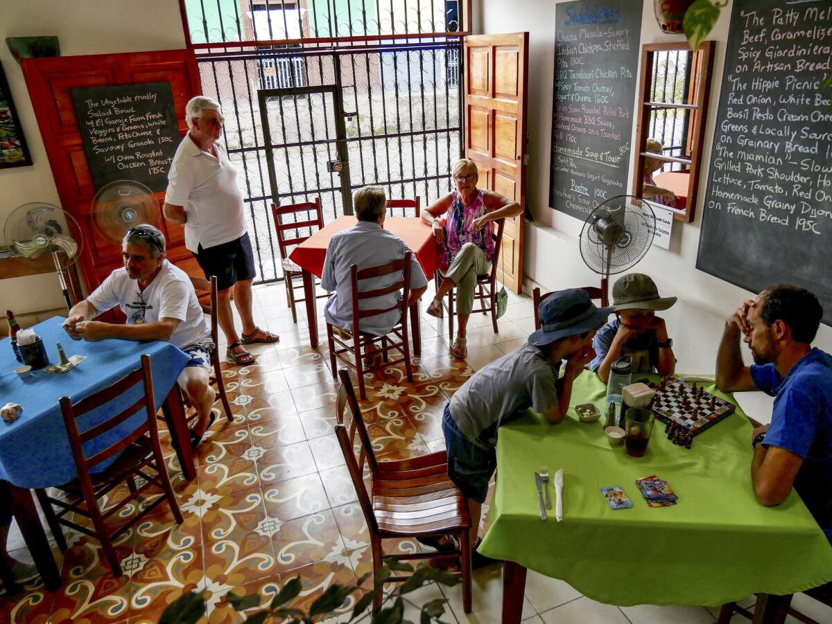 Tim Waring plays chess with Liam and Reid while the family waits for lunch at Restaurante El Garaje in Granada. (Katie Quirk)