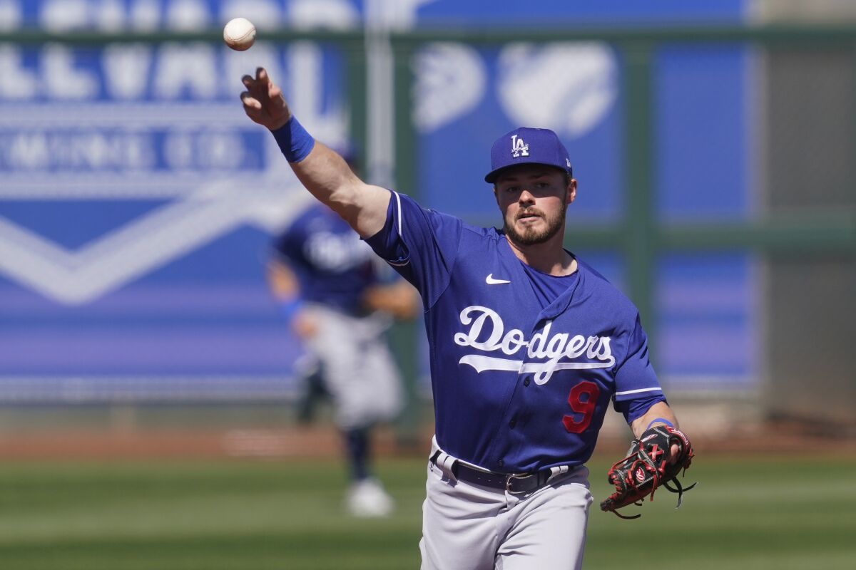 Dodgers second baseman Gavin Lux throws during a spring training game against the Kansas City Royals on Friday.