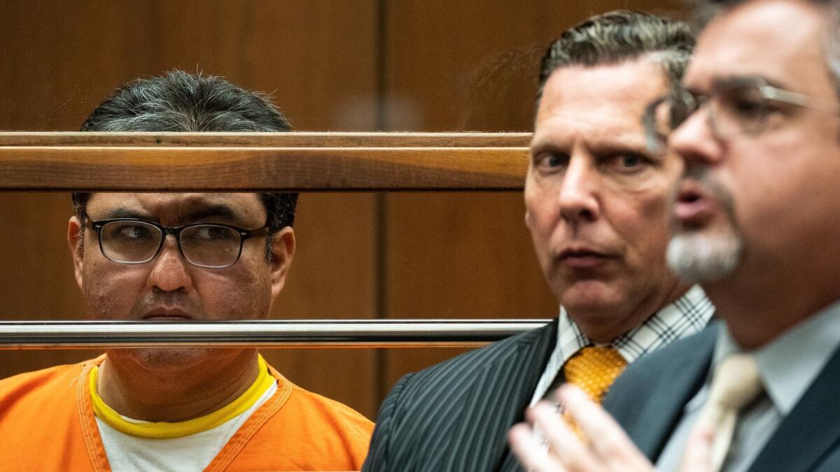 Naason Joaquin Garcia, leader of La Luz del Mundo church, with his attorneys at an arraignment and bail review in Los Angeles County Superior Court.